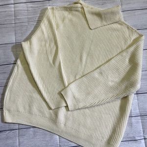 Cream colored sweater with button detail on the neck